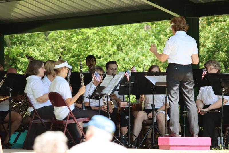 An image of some members of the Spirit of Independence Concert Band sitting outside at George Owens Nature Park pavilion playing at a concert.